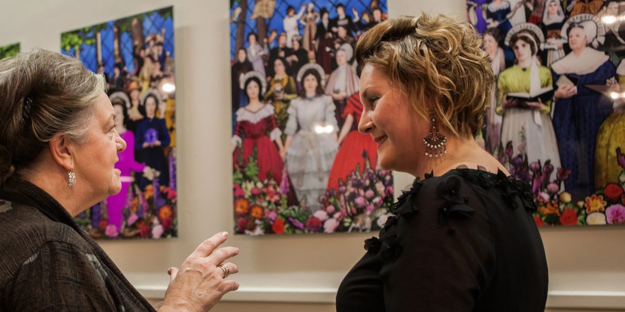 Artist Tracy Satchwill talking to a lady during the launch of Magna Carta Women tour, funded by ACE.