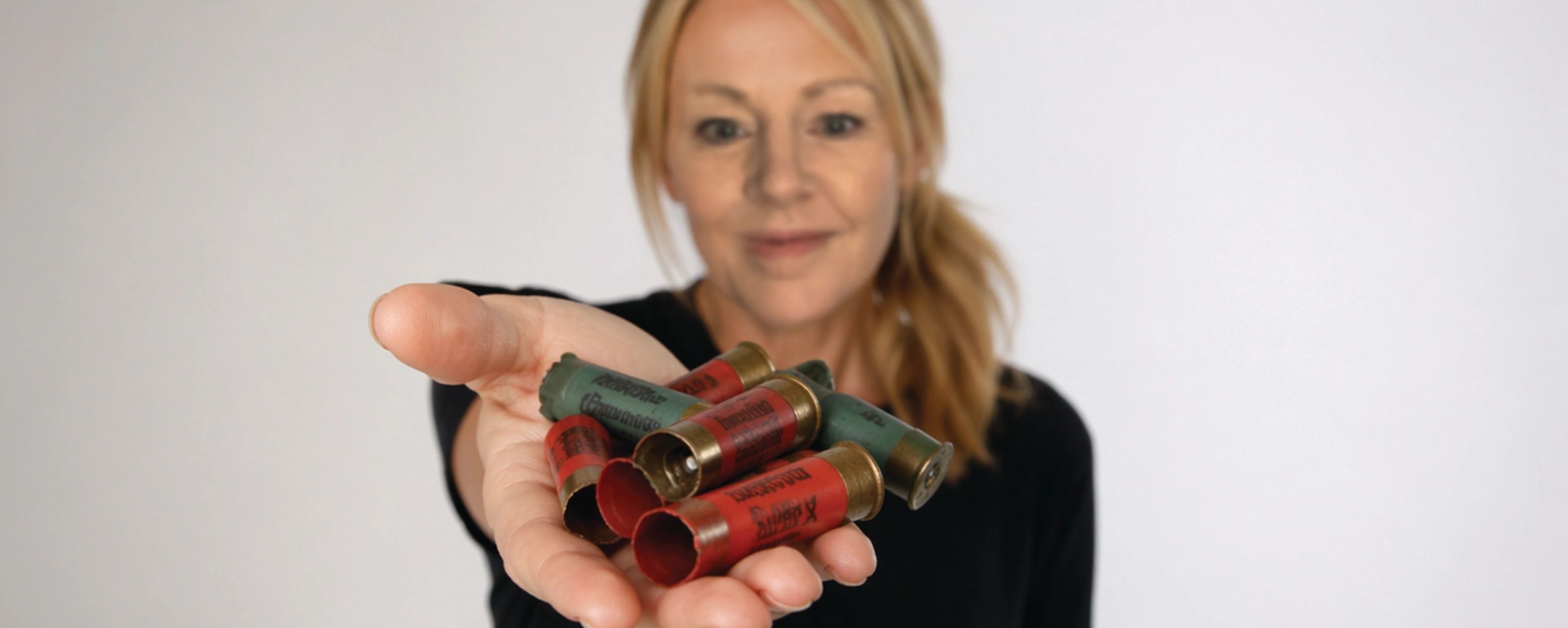 Woman-holding-empty-shotgun-shell-hulls