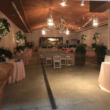 Elegant indoor event space with soft lighting and floral decorations.