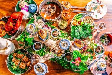 Farmhouse Thai popular dishes spread on wooden table. Birds eye view top shot
