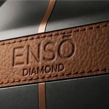 Close-up of a leather label embossed with 'ENSŌ DIAMOND' on a black surface.