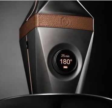 Close-up of a sleek black device with a digital display showing 25 min and 180°.
