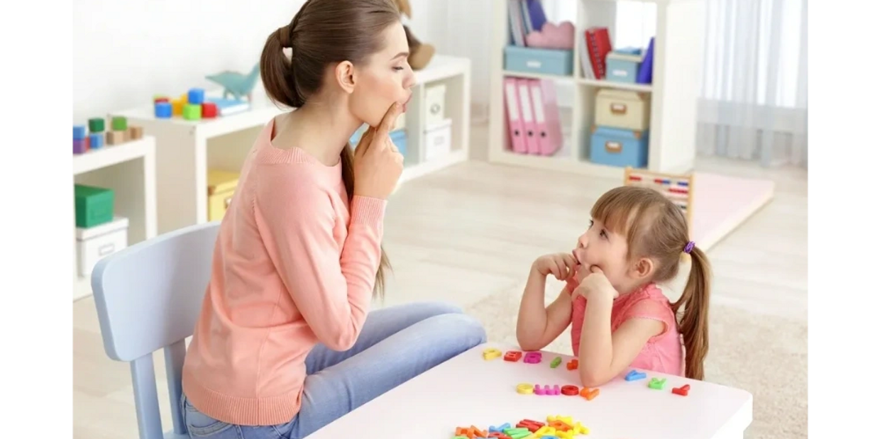 a little girl with her therapist doing speech therapy