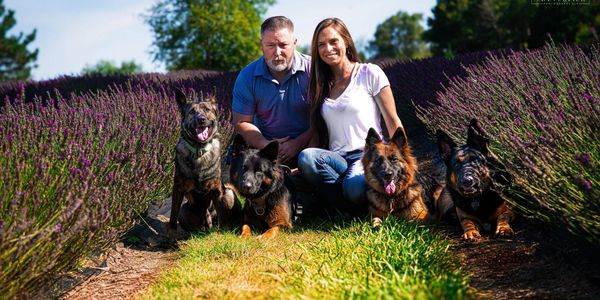 Stephanie, her husband and their pack minus one!