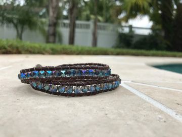 Wrap Bracelet with brown bolo leather and faceted crystals in denim blue. Adjustable double wrap.