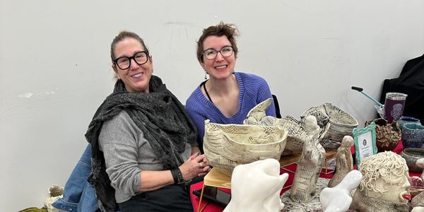 Two women selling their pottery at the Community Kiln Holiday Sale