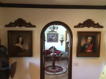 Two portraits astride the Sun Room's entrance at Sanibel Manor House.