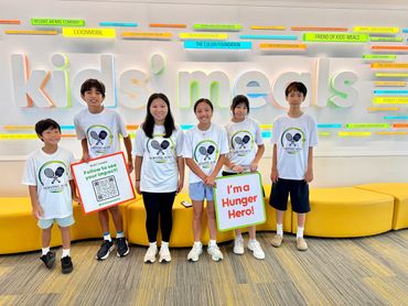 Group of kids wearing matching shirts at Kids' Meals.