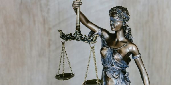 Statue of Lady Justice holding scales, blindfolded.