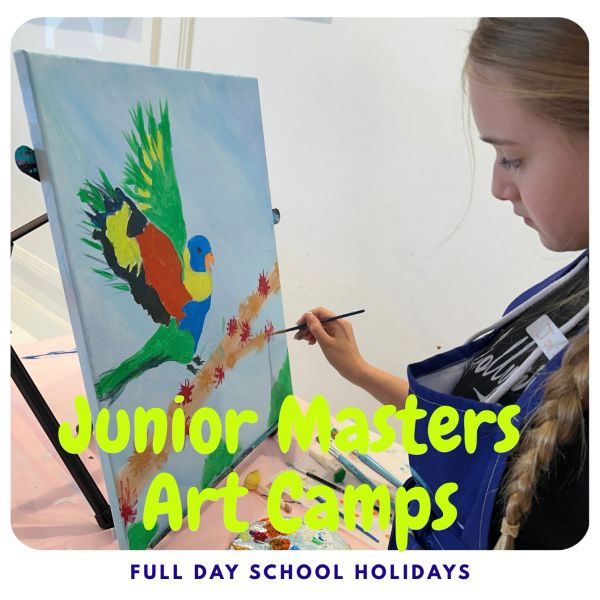 Child painting a colorful bird artwork at Junior Masters Art Camps.