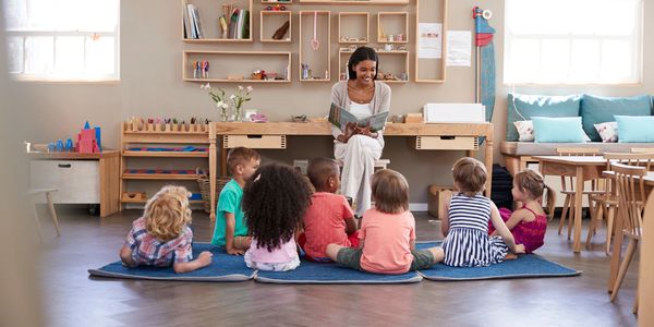 Teacher reading to children in a classroom.
