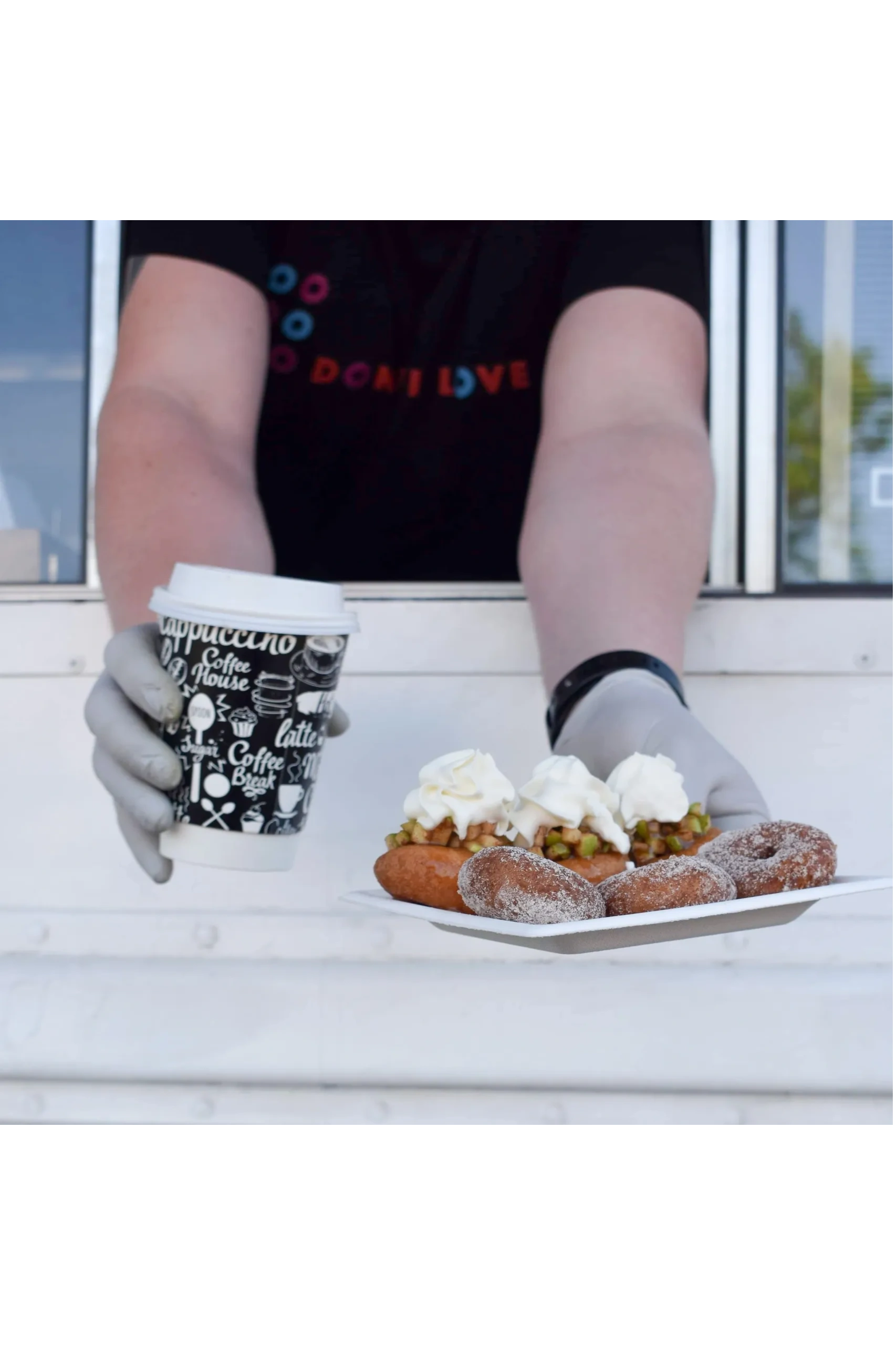 Donut I Love U worker handing out an order of gluten free donuts and coffee in Charlotte, NC