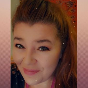 Smiling woman with light brown hair and starry filter effect.