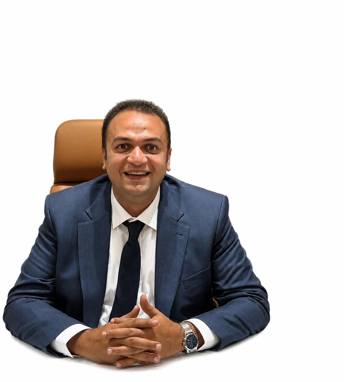 Smiling man in a blue suit sitting at a desk.