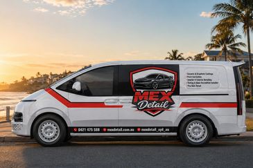 White van with MEX Detail branding parked by the beach at sunset.