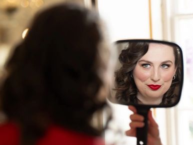 A lady looking at herself in a mirror