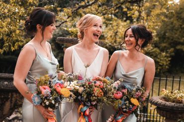 A bride laughing with her bridemaids