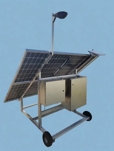 Mobile solar panel system with mounted light and control boxes.
