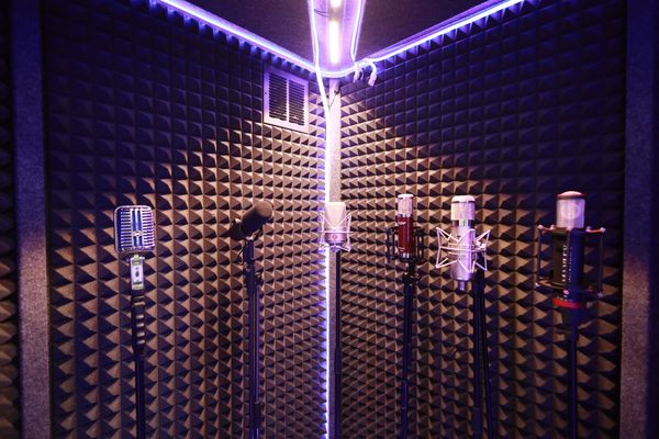 Vocal booth with mics and purple light