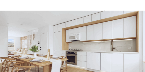 Modern kitchen and dining area with white cabinets and wooden furniture.