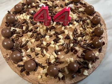 Chocolate cake with number 44 candles.