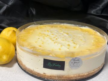 Lemon cheesecake in a clear container.
