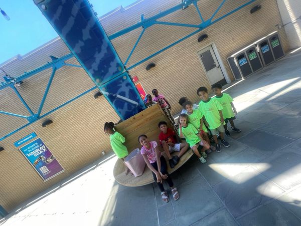 a group of kids sitting on a platform 