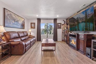 Cozy living room with leather sofa and large TV.