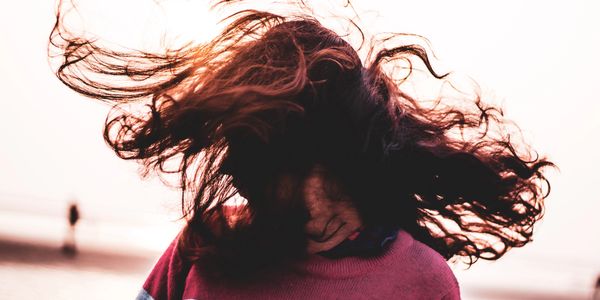 A woman flipping her hair while turning her head quickly.