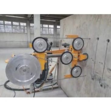 Wall-mounted wire rope machinery with multiple pulleys.