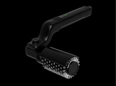 Black handheld electric cleaning brush with bristles and LED indicators.