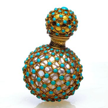 Antique gold and turquoise perfume bottle shot  white background, highlighting luxury product detail