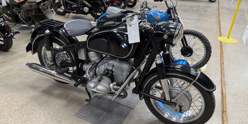 Classic black BMW motorcycle on display in a showroom.