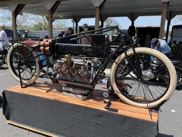Vintage motorcycle with a unique engine design on display at an outdoor event.
