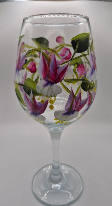 Wine glass with hand-painted floral design.