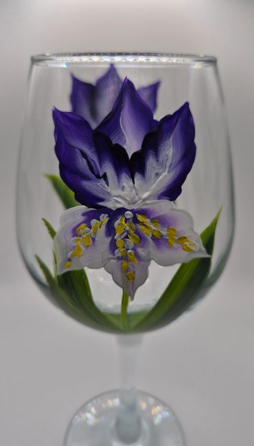 Purple flower painted inside a wine glass.