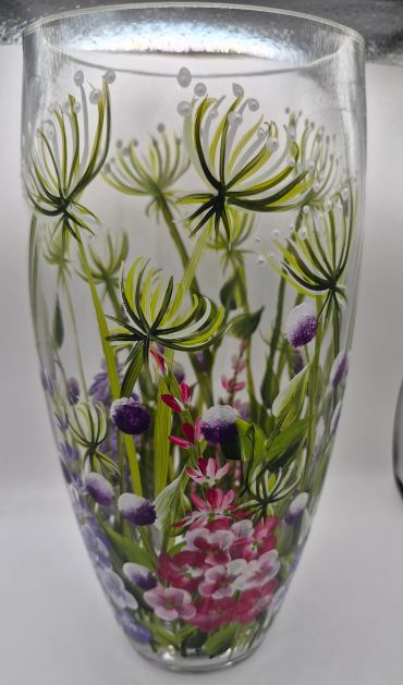 Glass vase with painted floral design.