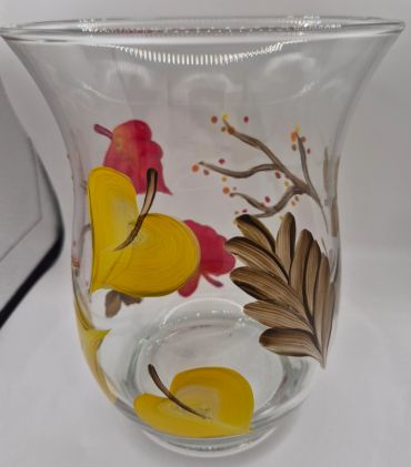 Clear glass vase with colorful floral designs.