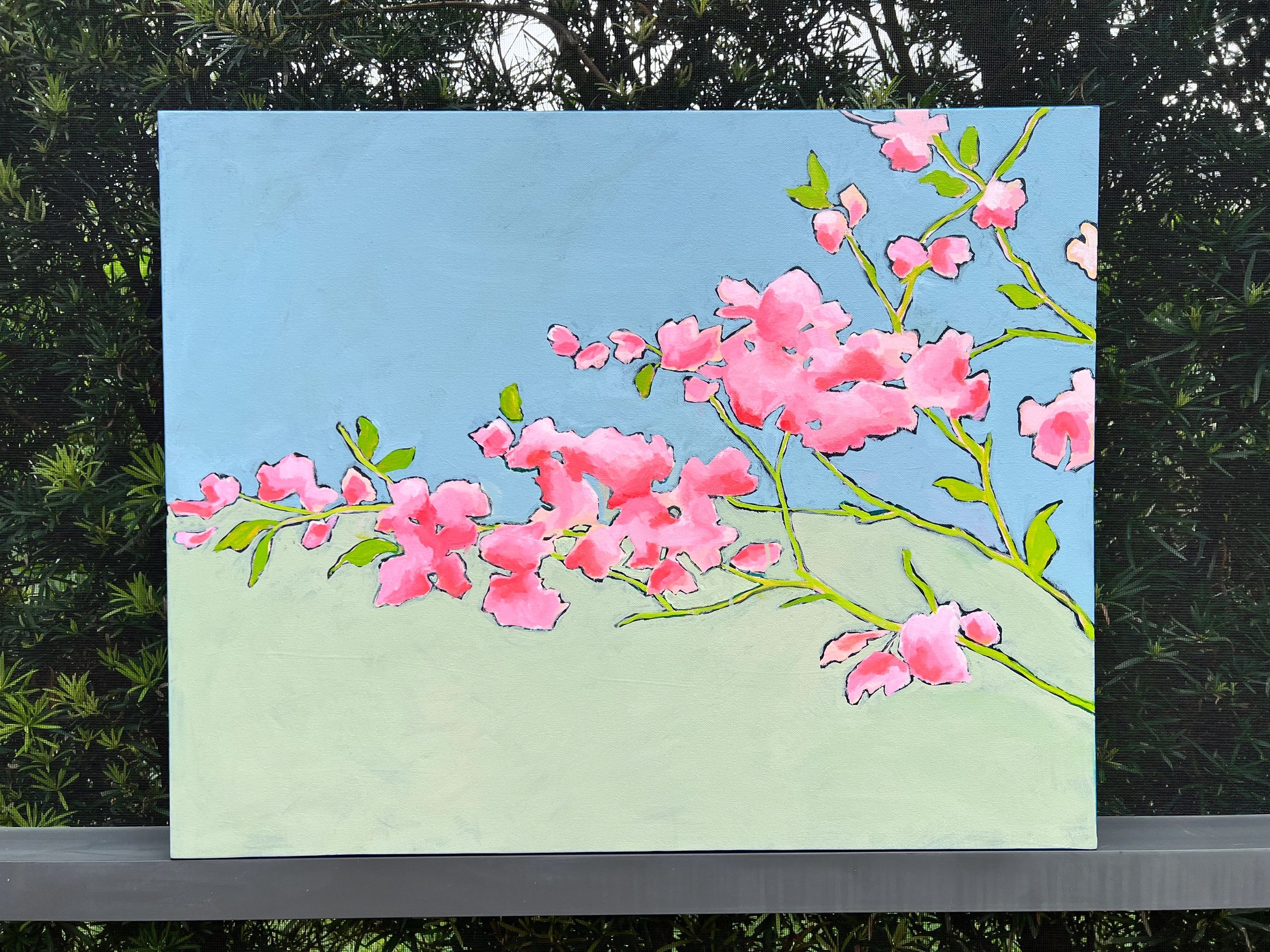 Painting of pink blossoms against a blue and light green background.