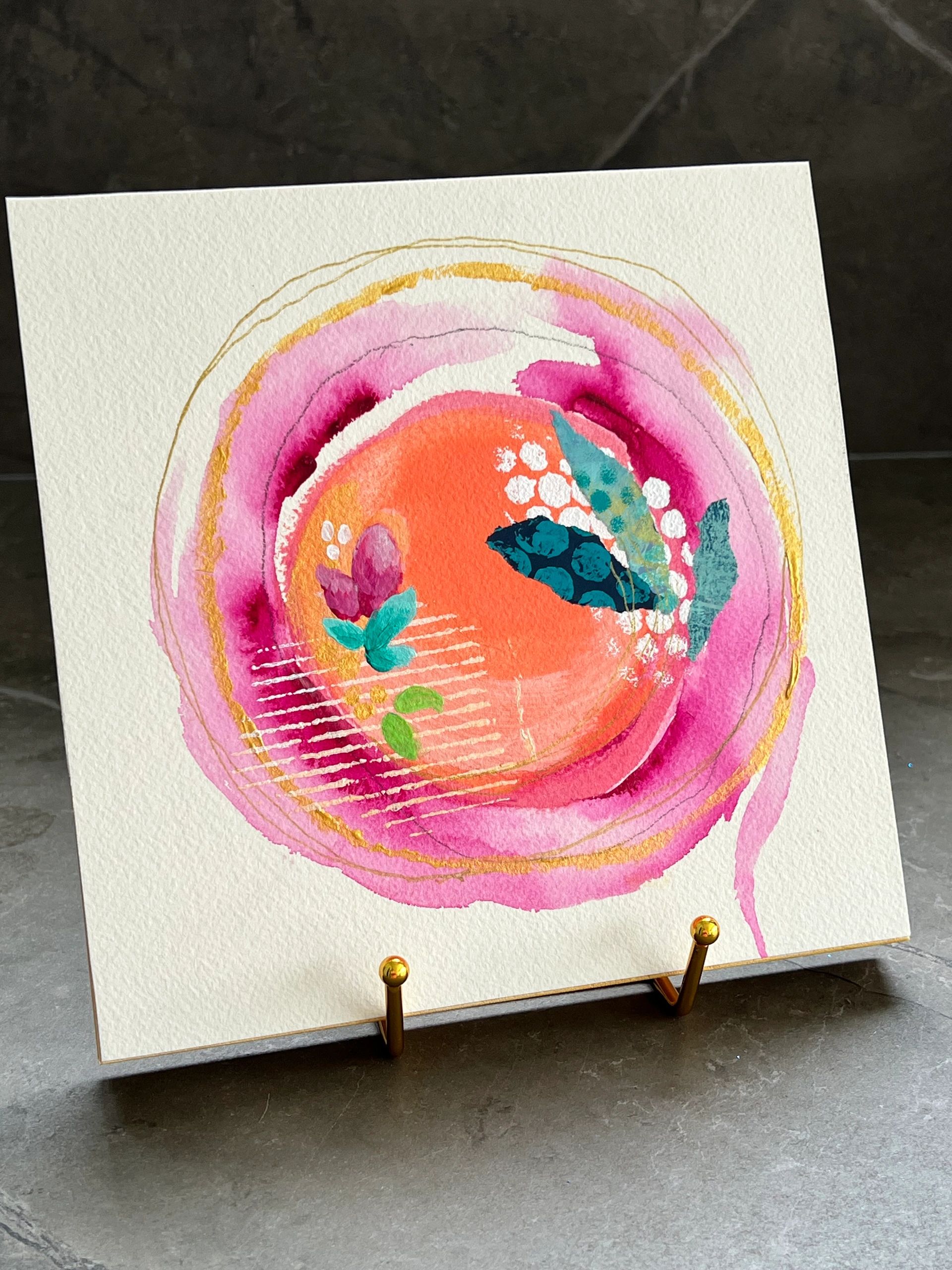 Abstract watercolor painting with vibrant pink, orange, and teal colors.