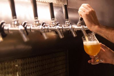 A person pouring beer into a glass