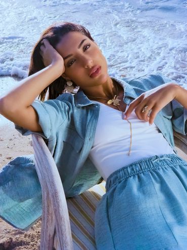 Woman relaxing on a beach chair near the ocean waves.