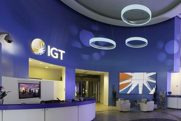 Modern casino lobby with slot machines and seating area under blue lighting.