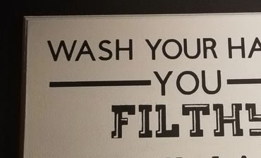 Partial sign instructing to wash hands, calling the reader filth.
