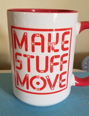 White mug with red text 'MAKE STUFF MOVE'.