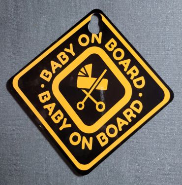 Yellow and black 'Baby on Board' sign with a stroller icon.