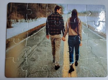 Puzzle of a couple walking hand in hand on a road.