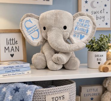 Plush elephant toy with personalized details in a child's room.