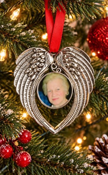 Angel wings photo frame ornament on Christmas tree.