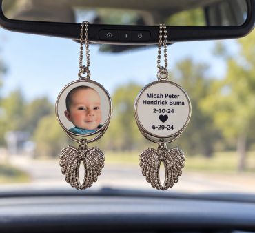 Car mirror hanging photo frame with baby picture and memorial text.